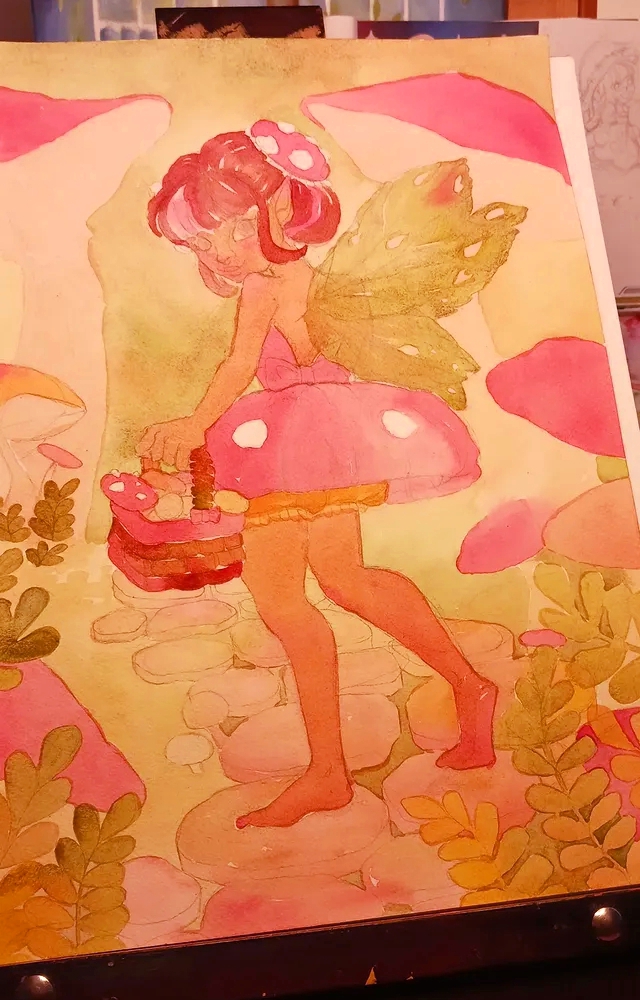 Fantasy art watercolor process photo of a mushroom fairy illustration with green wings and pink mushroom space buns in a whimsical mushroom forest