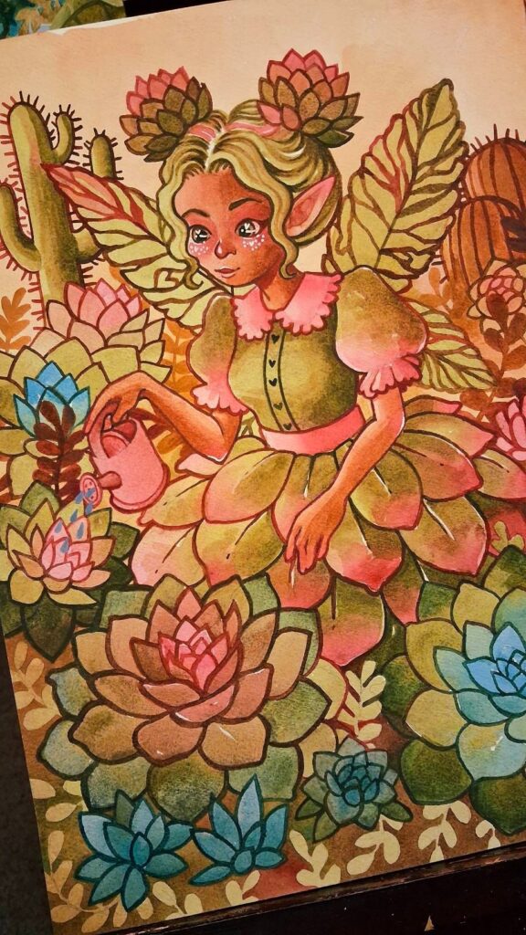 Finished illustration of a succulent fairy with succulent space buns, large green wings, a pink‑and‑green petal dress, and floral face markings. She holds a pink watering can and waters a cluster of colorful succulents surrounded by tall cacti. The scene is vibrant and detailed, with rich greens, blues, and pinks throughout. Made with watercolor.
